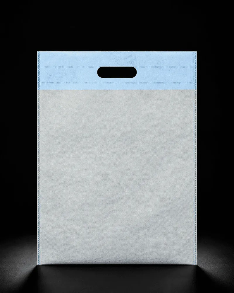 White and blue D-Cut non-woven carry bag with custom logo printing by Vaibhav Enterprise